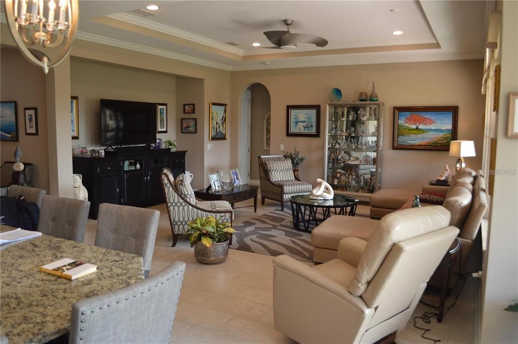 32026 Wenlock Loop Wesley Chapel, FL 33543 - Photo 17 of 52 a living room with furniture and a flat screen tv