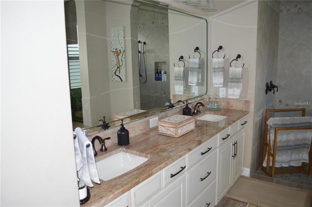 32026 Wenlock Loop Wesley Chapel, FL 33543 - Photo 36 of 52 a bathroom with double vanity sinks and a mirror