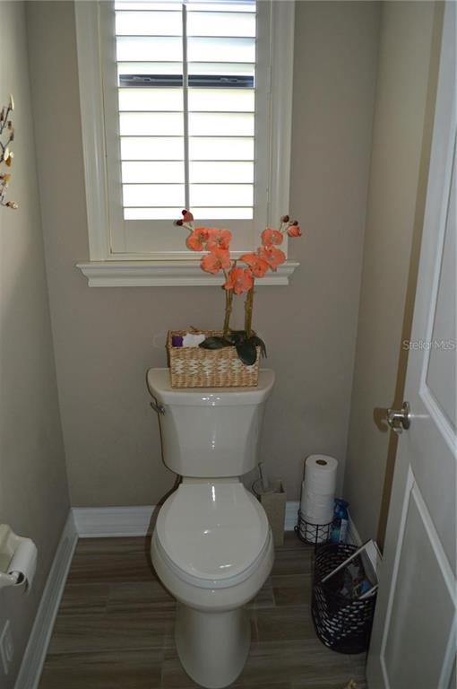 32026 Wenlock Loop Wesley Chapel, FL 33543 - Photo 42 of 52 a bathroom with a toilet sink and mirror