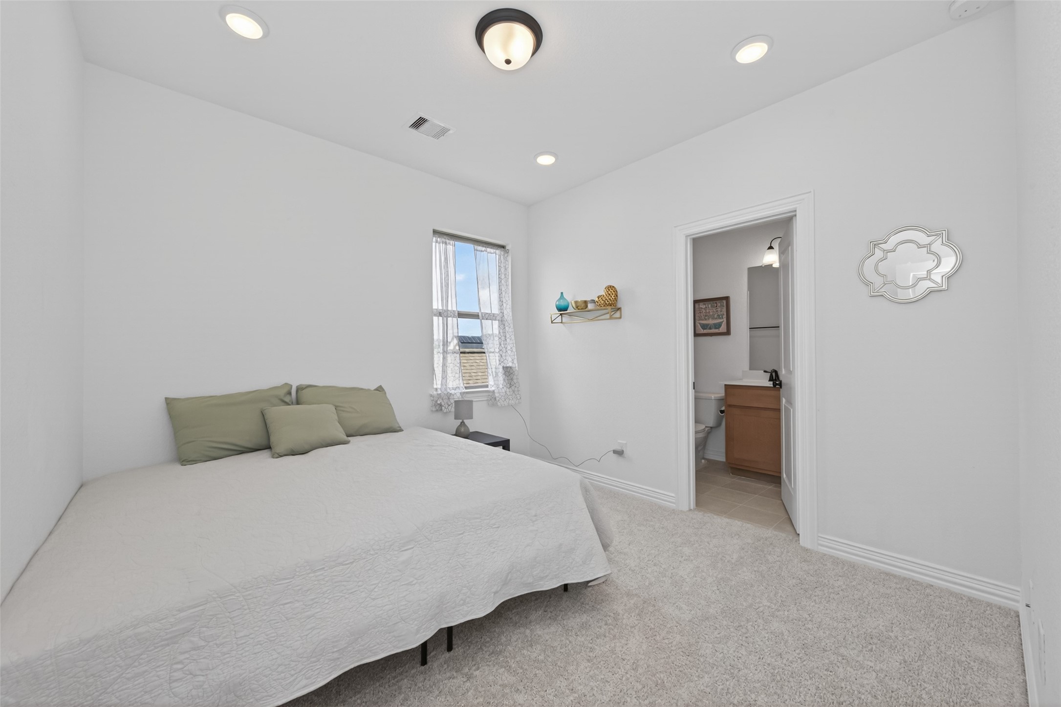 20802 Mirror Point Drive Cypress, TX 77433 - Photo 15 of 37 A comfortable bedroom with an attached bathroom, ideal for guests offering convenience and privacy. This space provides a relaxing retreat, perfect for visitors seeking comfort and their own personal sanctuary within the home.