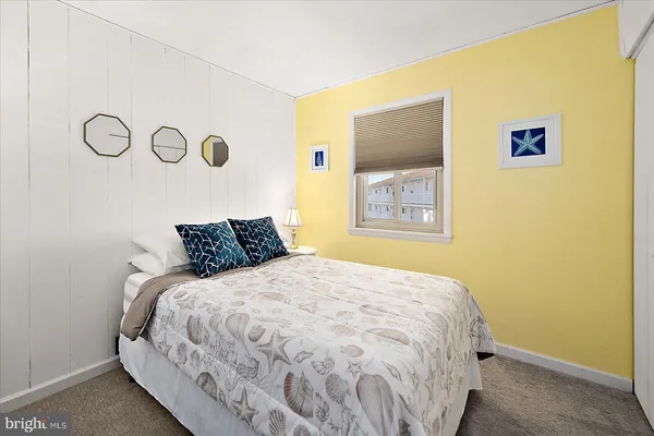a large bed in a bedroom next to a blue wall