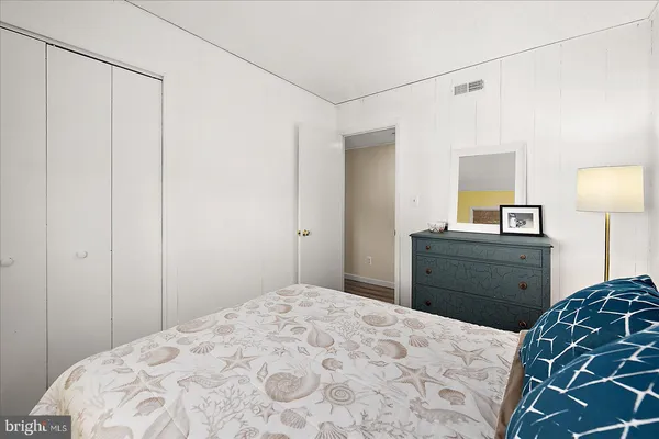 a bedroom with a bed and a dresser