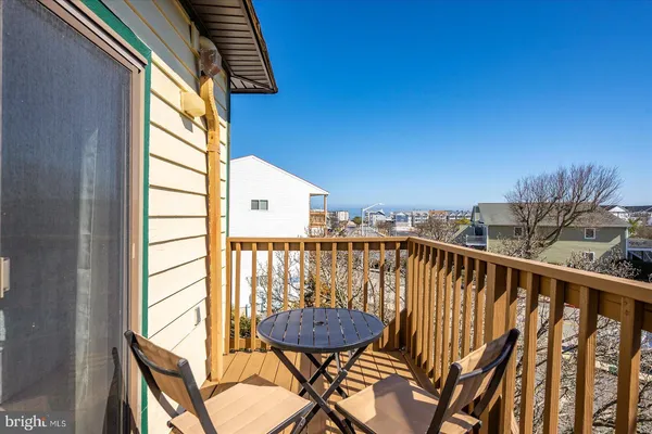 a view of a balcony with furniture and wooden floor