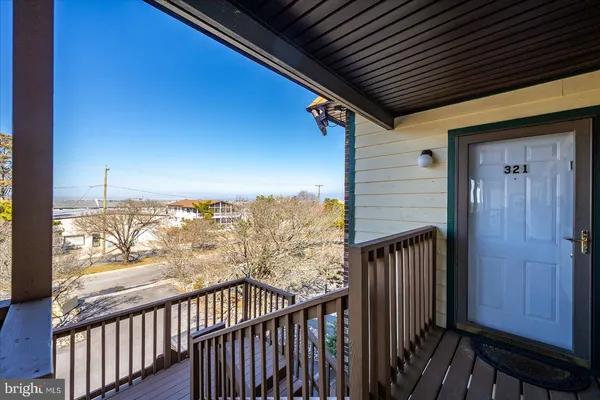a view of a balcony with wooden floor