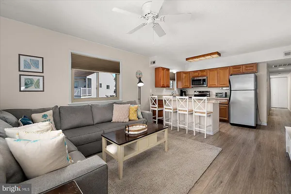 a living room with furniture and kitchen view