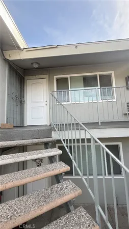 a view of staircase with white walls and a window