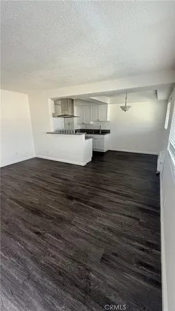 a kitchen with granite countertop a stove and a refrigerator