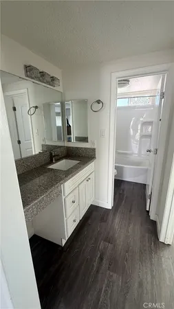 a bathroom with a granite countertop sink