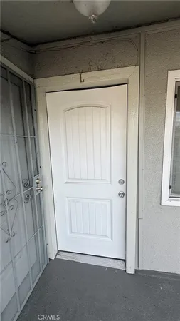 a view of staircase with white walls and a window