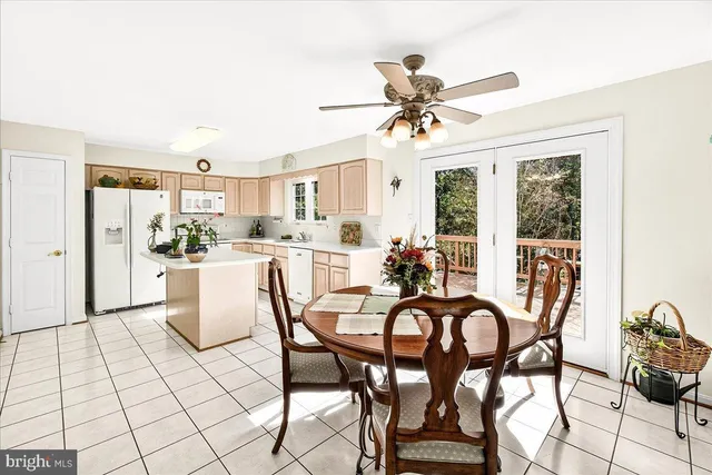 a kitchen with stainless steel appliances a sink a stove a refrigerator and cabinets