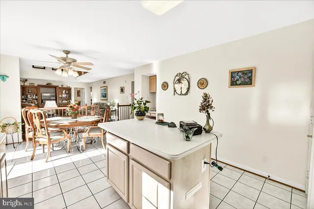 a dining room with furniture a chandelier and window