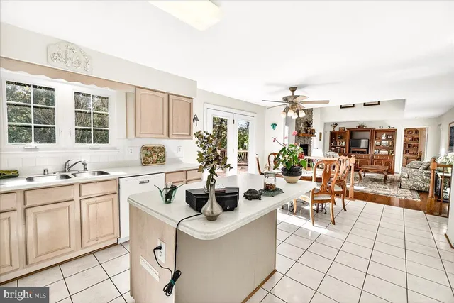 a kitchen with stainless steel appliances a stove a refrigerator and a white cabinets