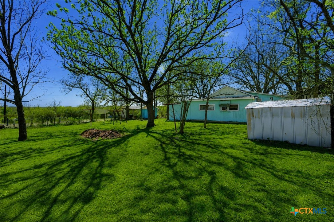 1631 East Fannin Street Luling, TX 78648 - Photo 2 of 27 a view of a backyard with large trees