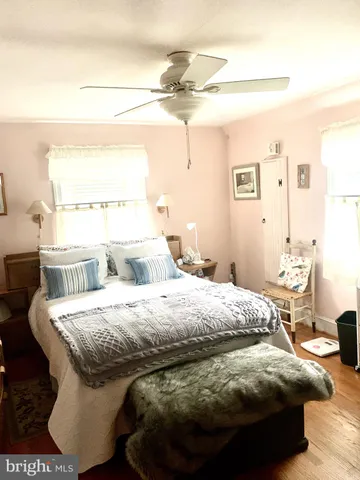 a living room with a table chair and a large window
