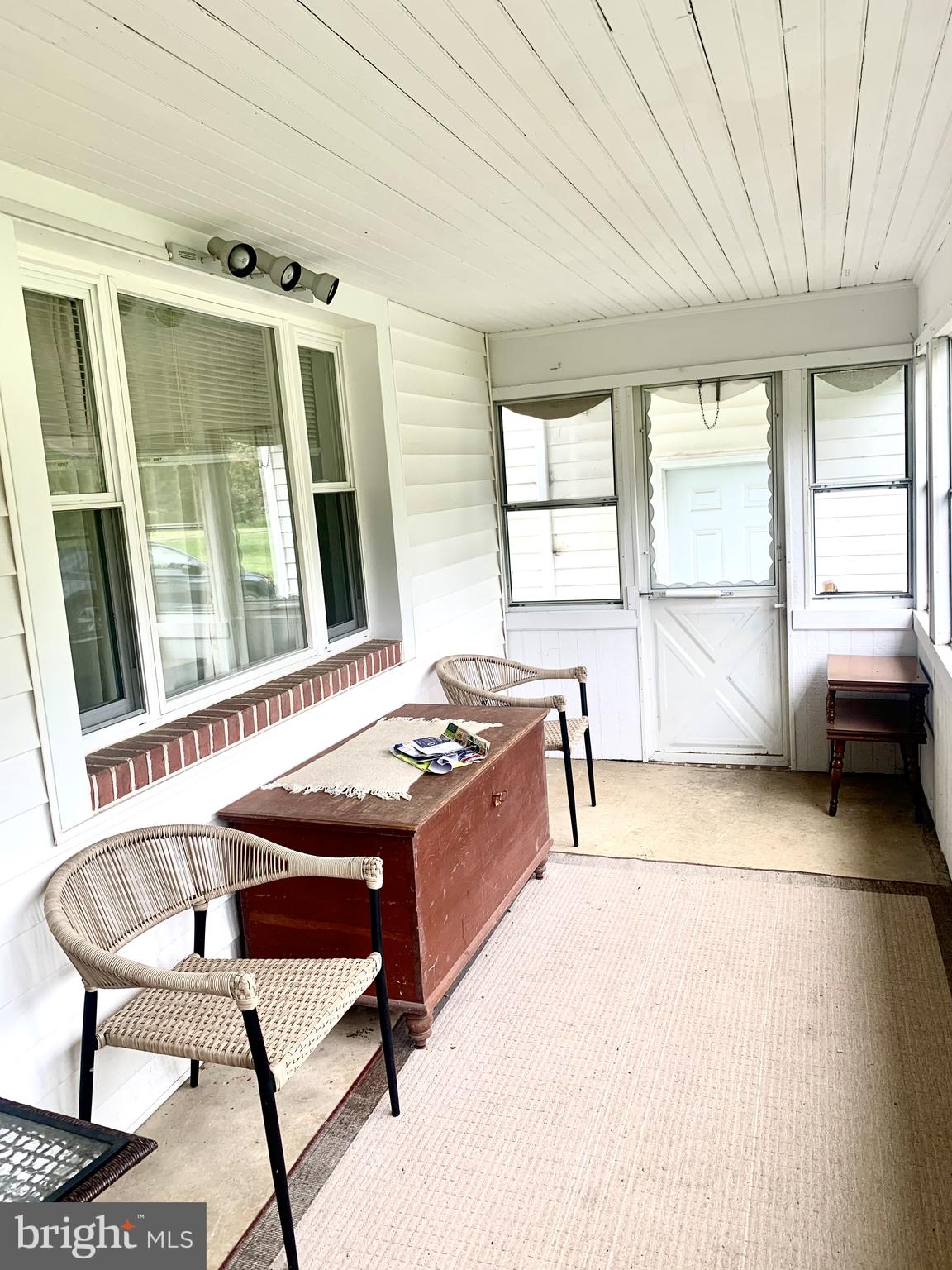 832 Evanson Road Hockessin, DE 19707 - Photo 13 of 13 a living room with a table chair and a large window