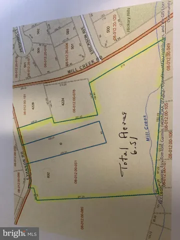 a view of a house with a yard and trees