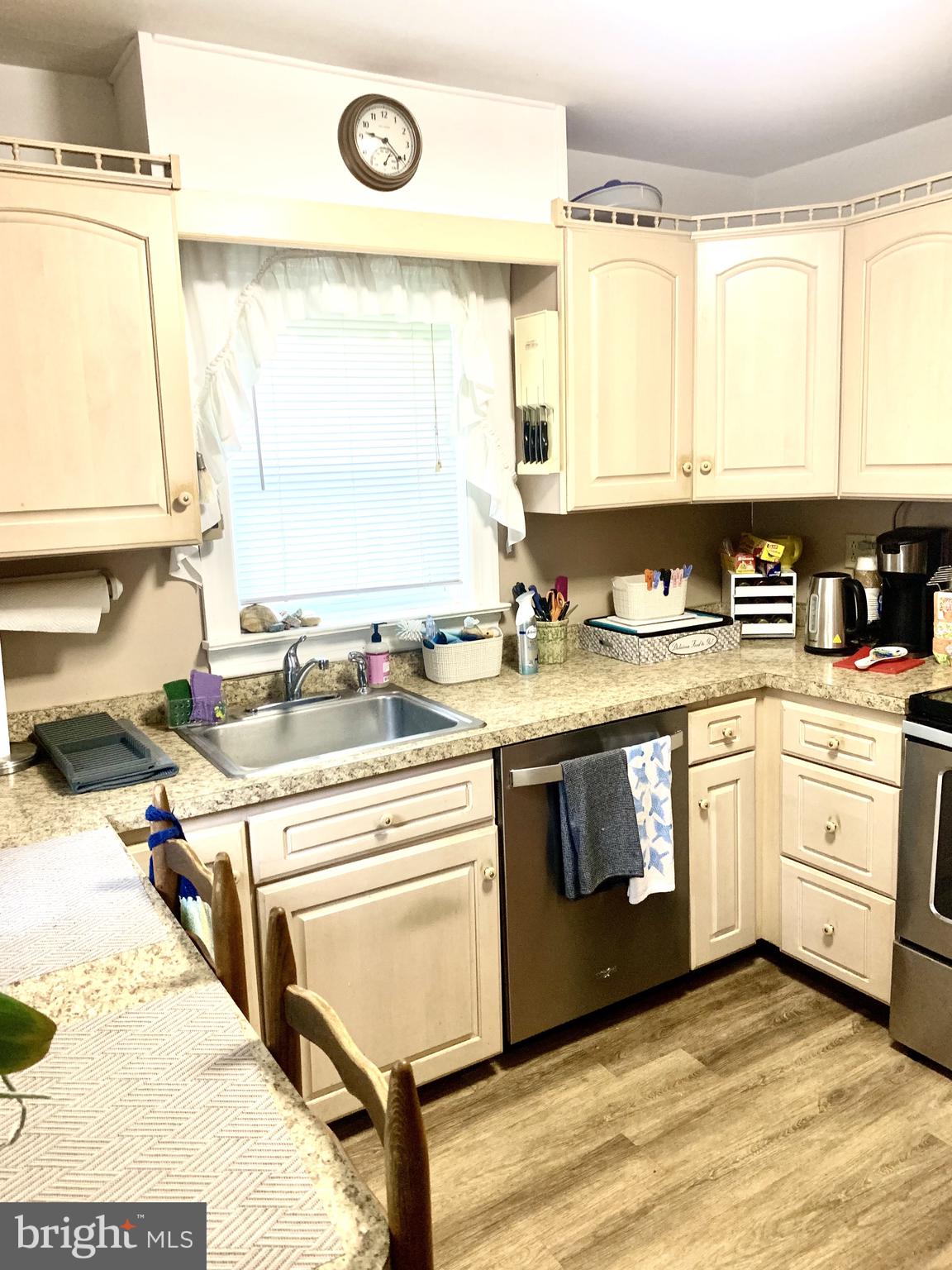 832 Evanson Road Hockessin, DE 19707 - Photo 9 of 13 a kitchen with a stove a sink and a microwave