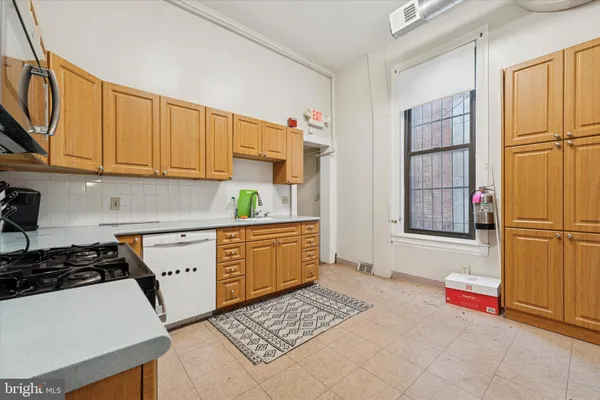 a kitchen with stainless steel appliances a refrigerator sink and cabinets