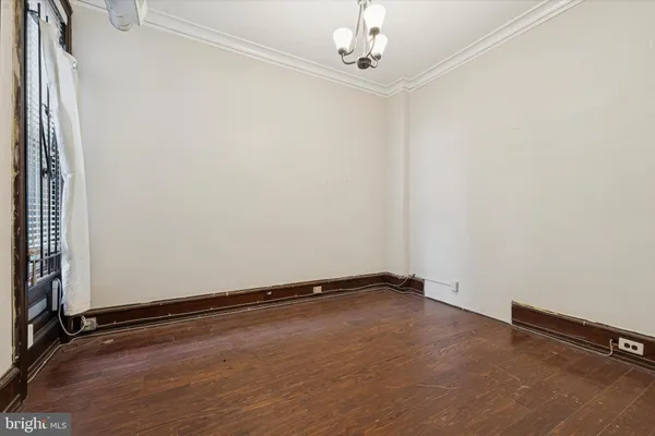 an empty room with wooden floor