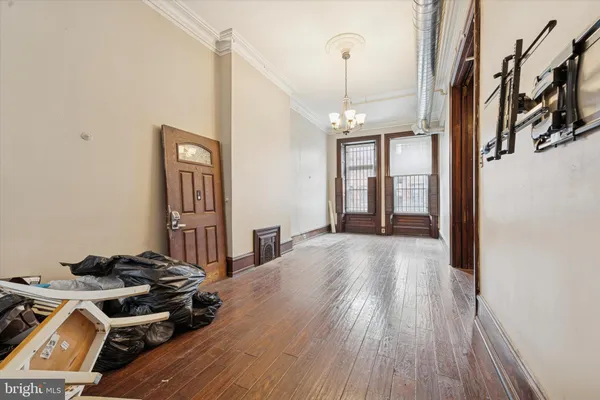 a view of a livingroom with wooden floor and stairs