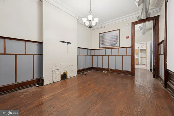 a view of a livingroom with wooden floor and a ceiling fan