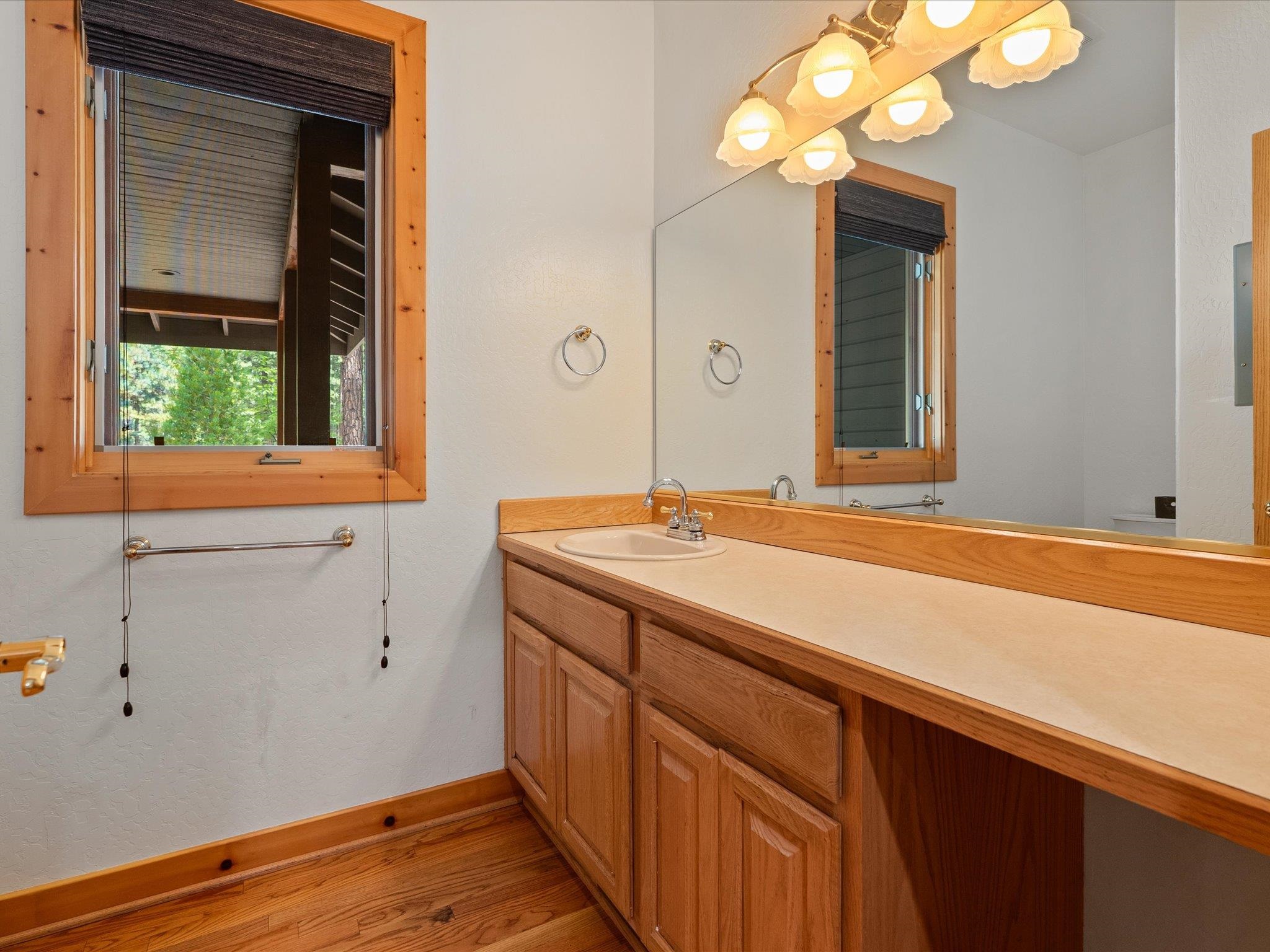 355 Quail View Circle Clio, CA 96106 - Photo 27 of 48 a bathroom with a sink and a large mirror