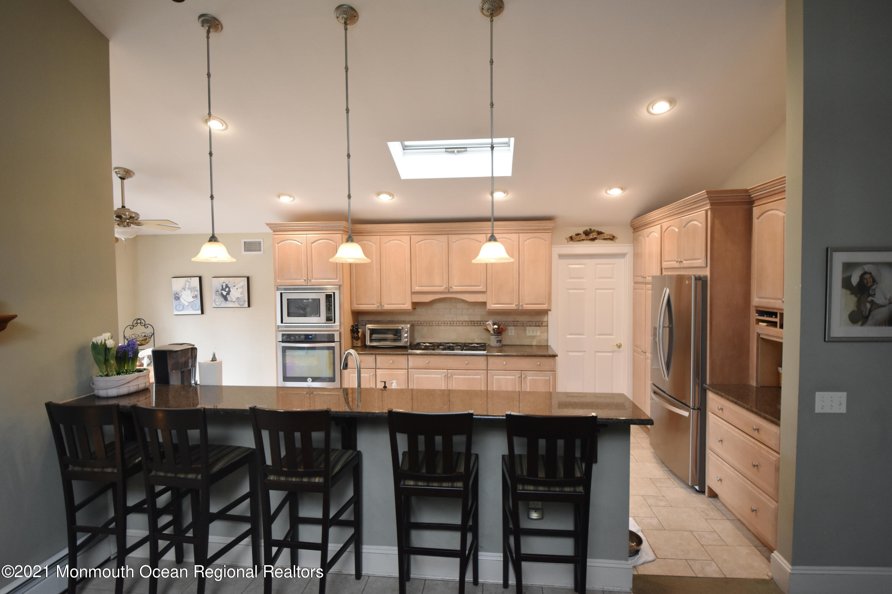 1007 Cedar Lane Brielle, NJ 08730 - Photo 14 of 46 a kitchen with stainless steel appliances granite countertop a kitchen island a stove and a dining table