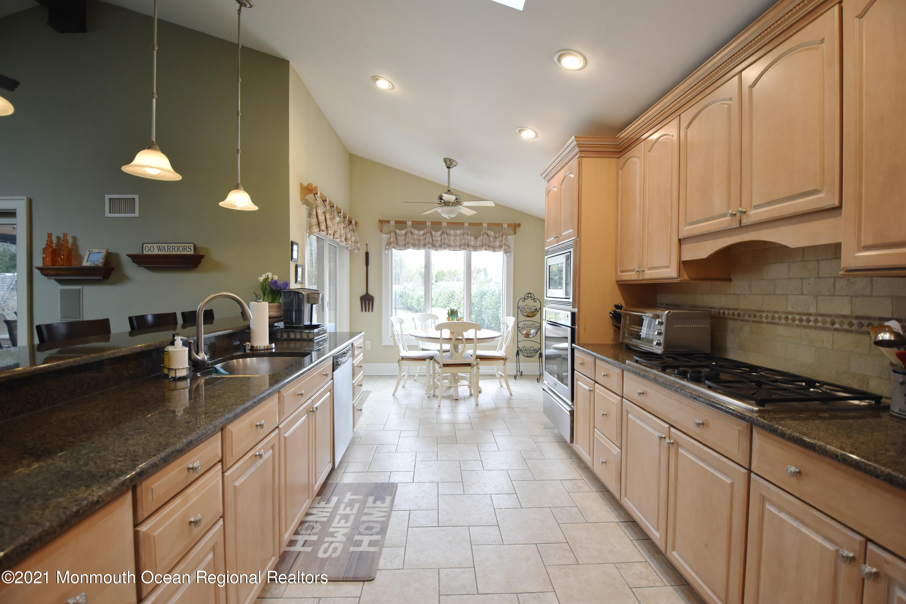 1007 Cedar Lane Brielle, NJ 08730 - Photo 15 of 46 a kitchen with counter top space a sink a stove and cabinets