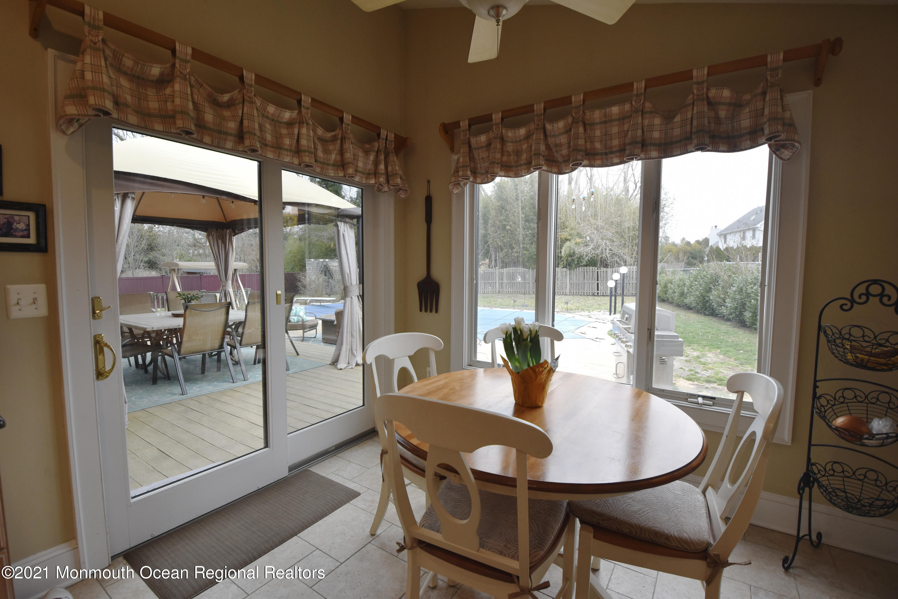 1007 Cedar Lane Brielle, NJ 08730 - Photo 16 of 46 a dining room with furniture a chandelier and glass door