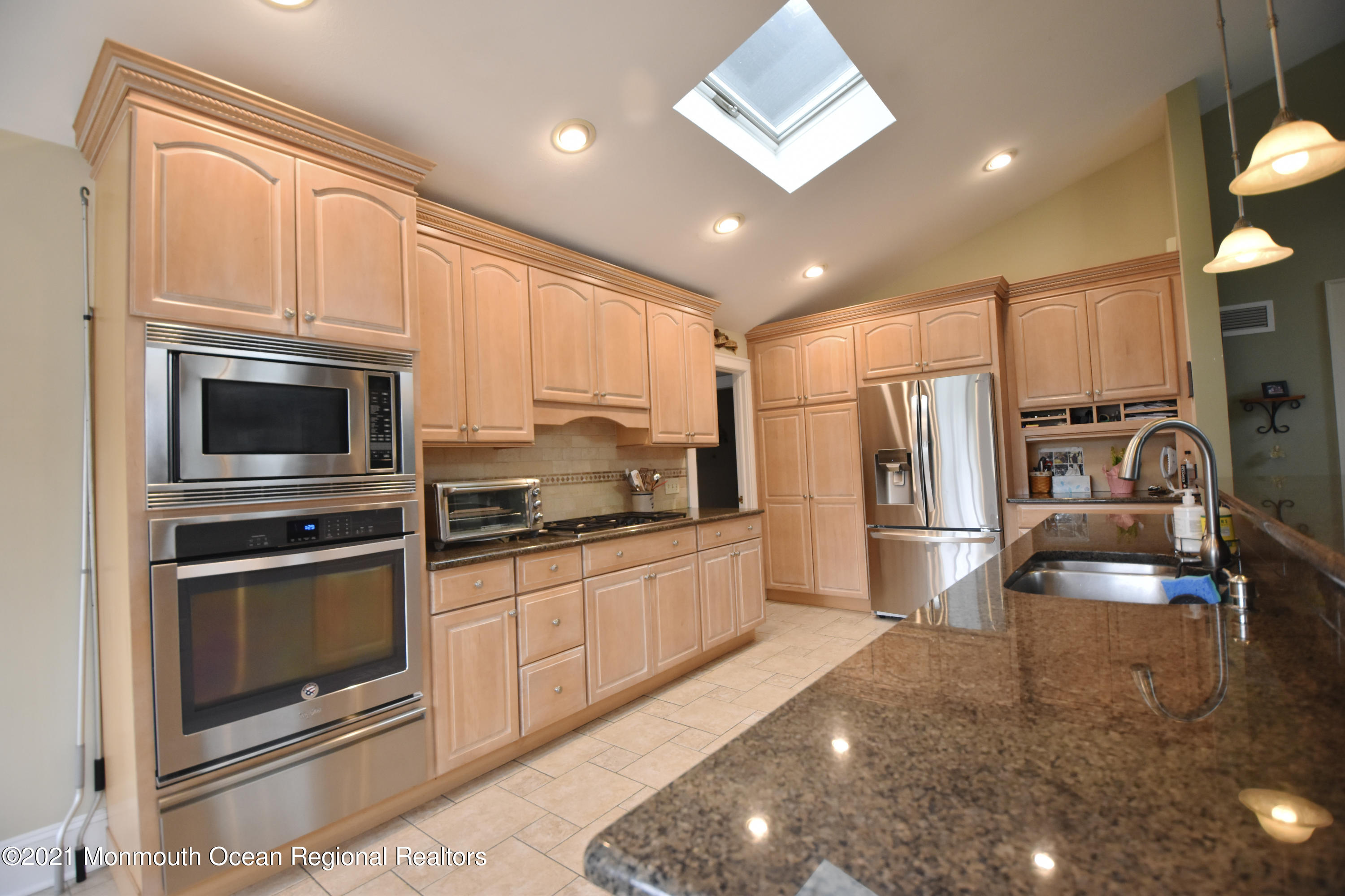 1007 Cedar Lane Brielle, NJ 08730 - Photo 18 of 46 a kitchen with stainless steel appliances granite countertop a stove a sink and a microwave