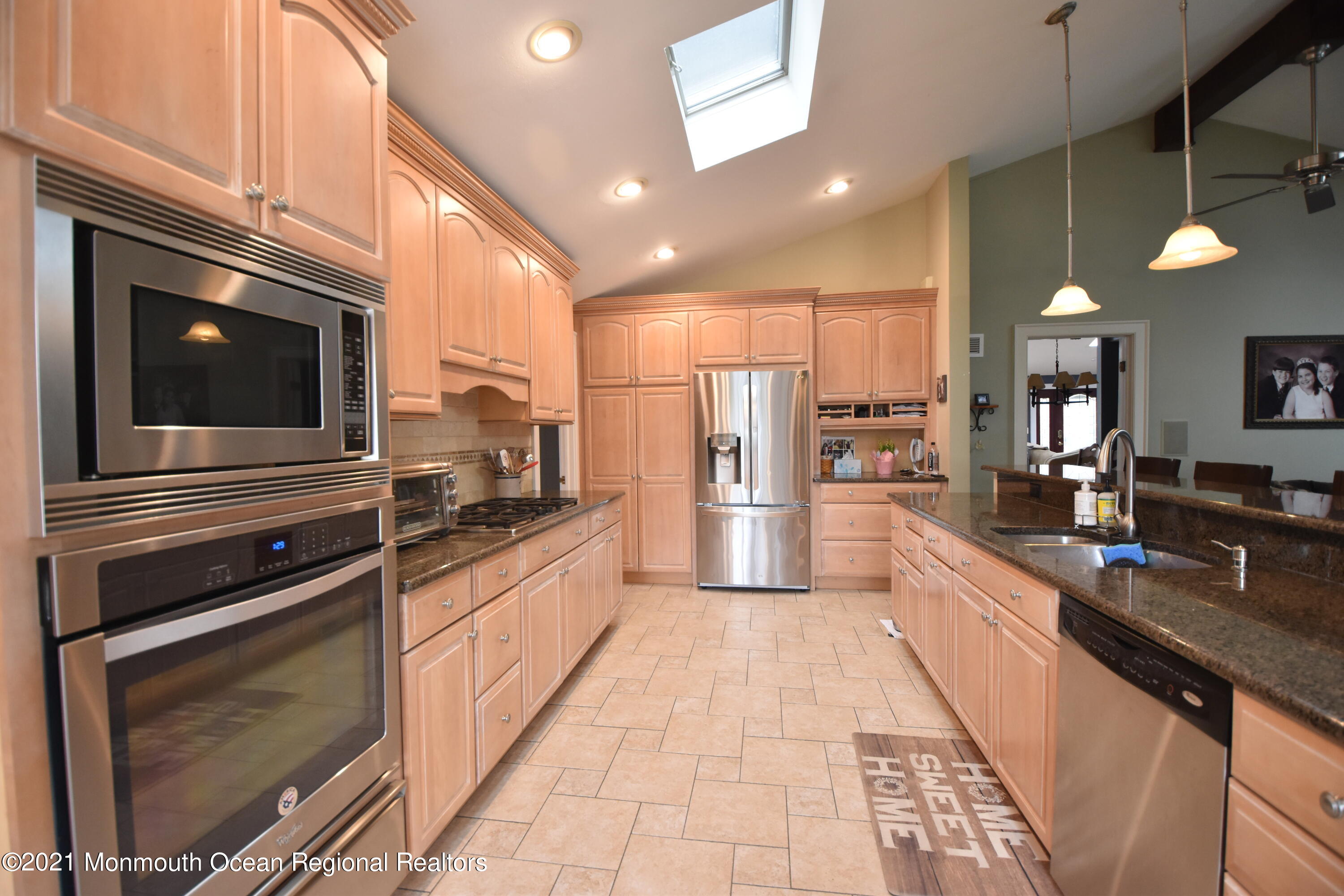 1007 Cedar Lane Brielle, NJ 08730 - Photo 19 of 46 a modern kitchen with stainless steel appliances and chandelier