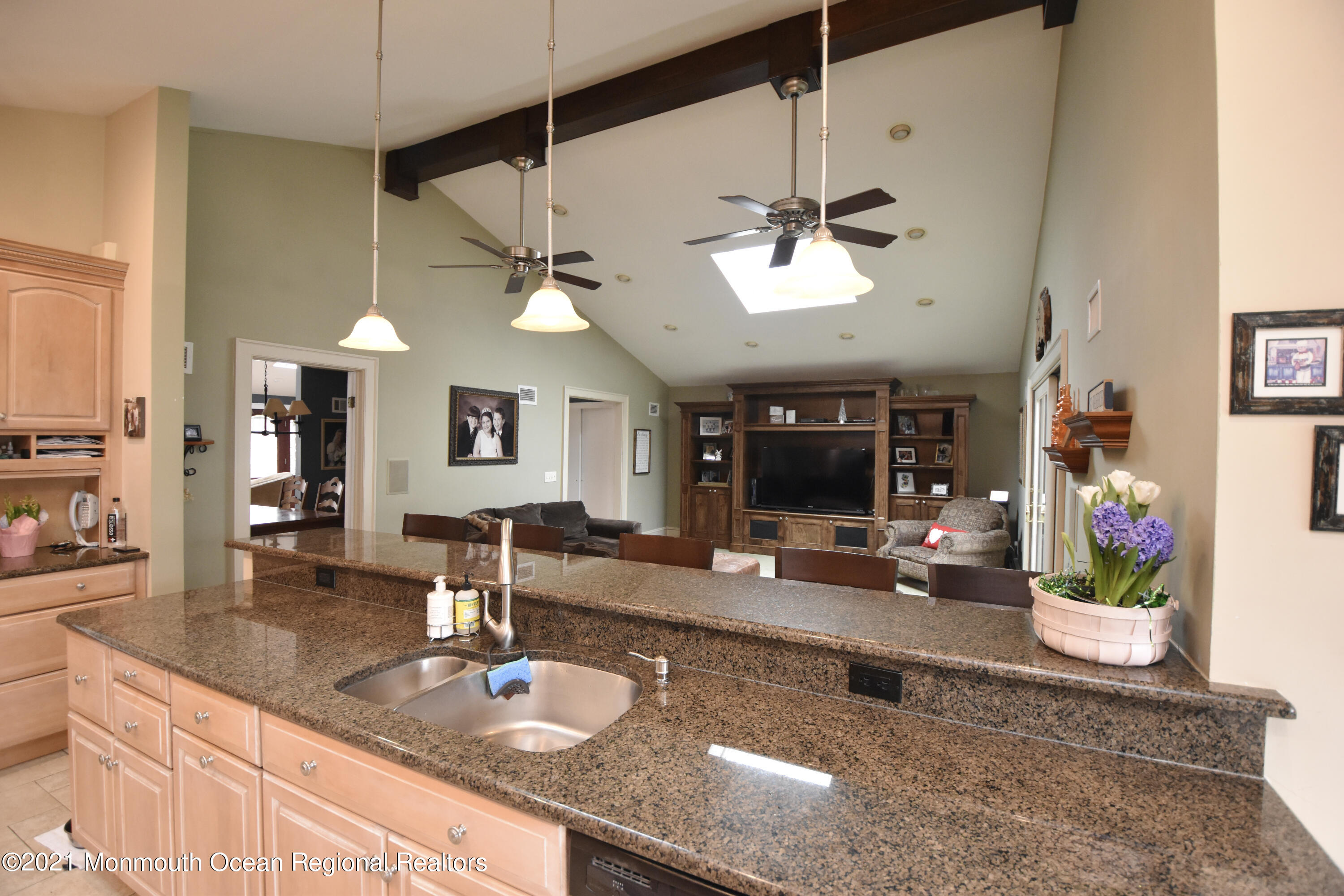 1007 Cedar Lane Brielle, NJ 08730 - Photo 20 of 46 a kitchen with a sink a counter space and a chandelier