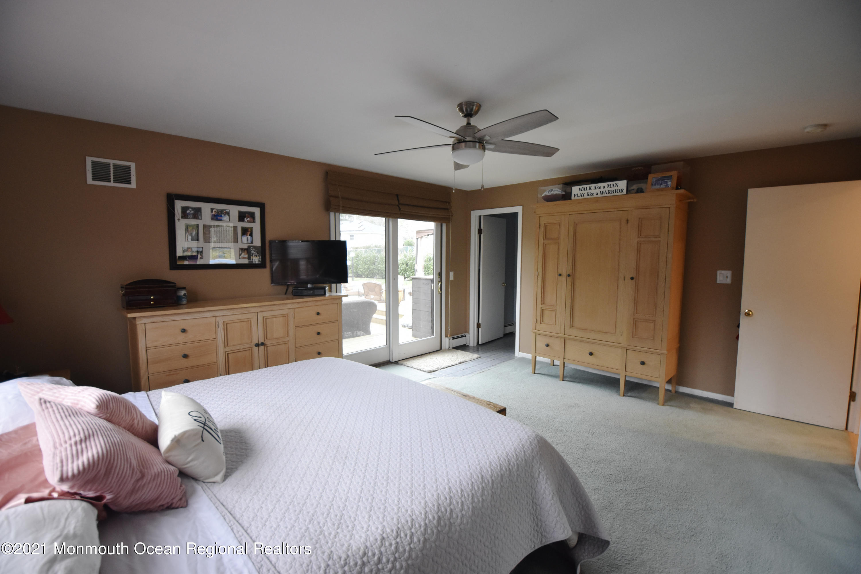 1007 Cedar Lane Brielle, NJ 08730 - Photo 23 of 46 a spacious bedroom with a bed and a flat screen tv