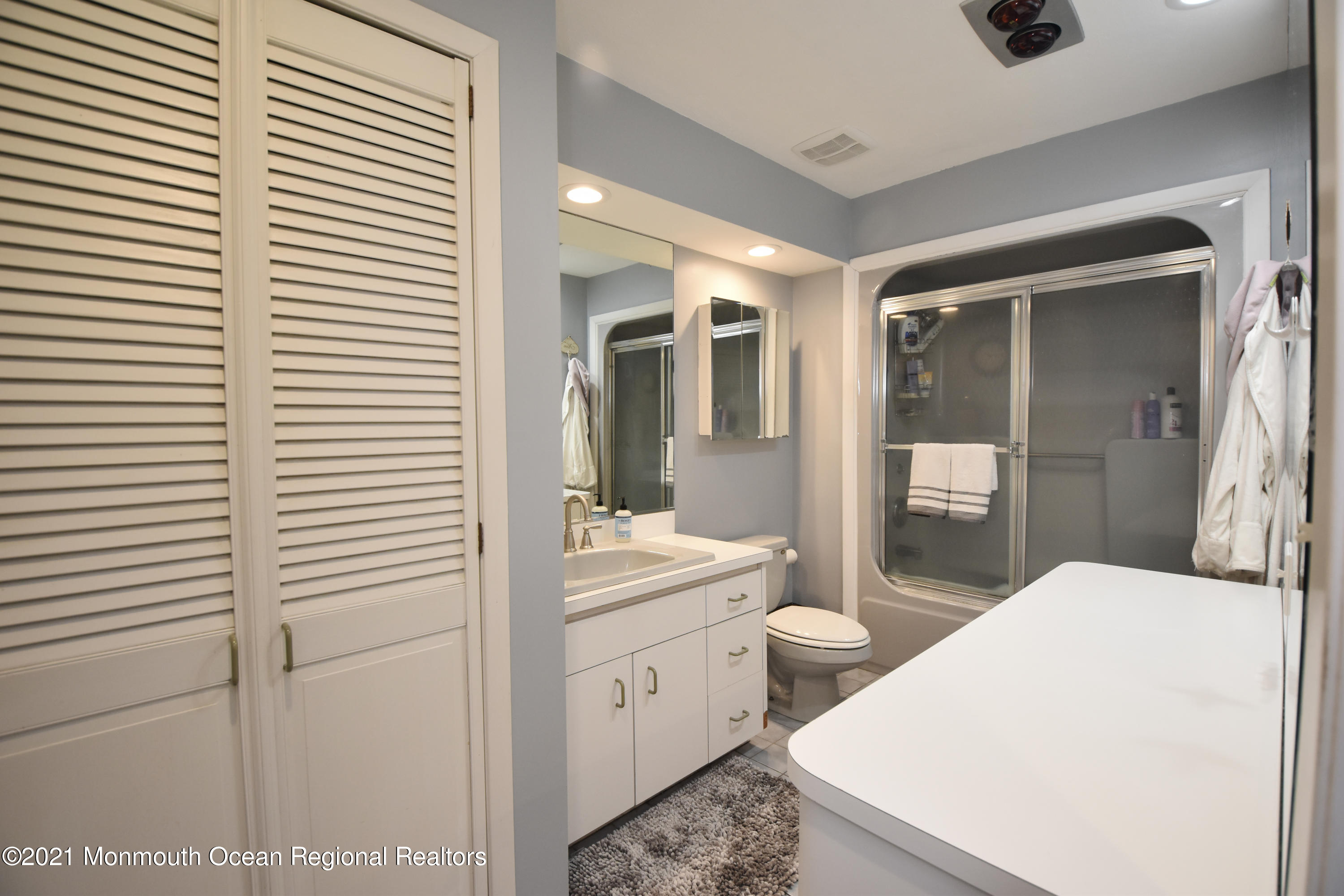 1007 Cedar Lane Brielle, NJ 08730 - Photo 25 of 46 a en suite bathroom with a sink a mirror and a shower