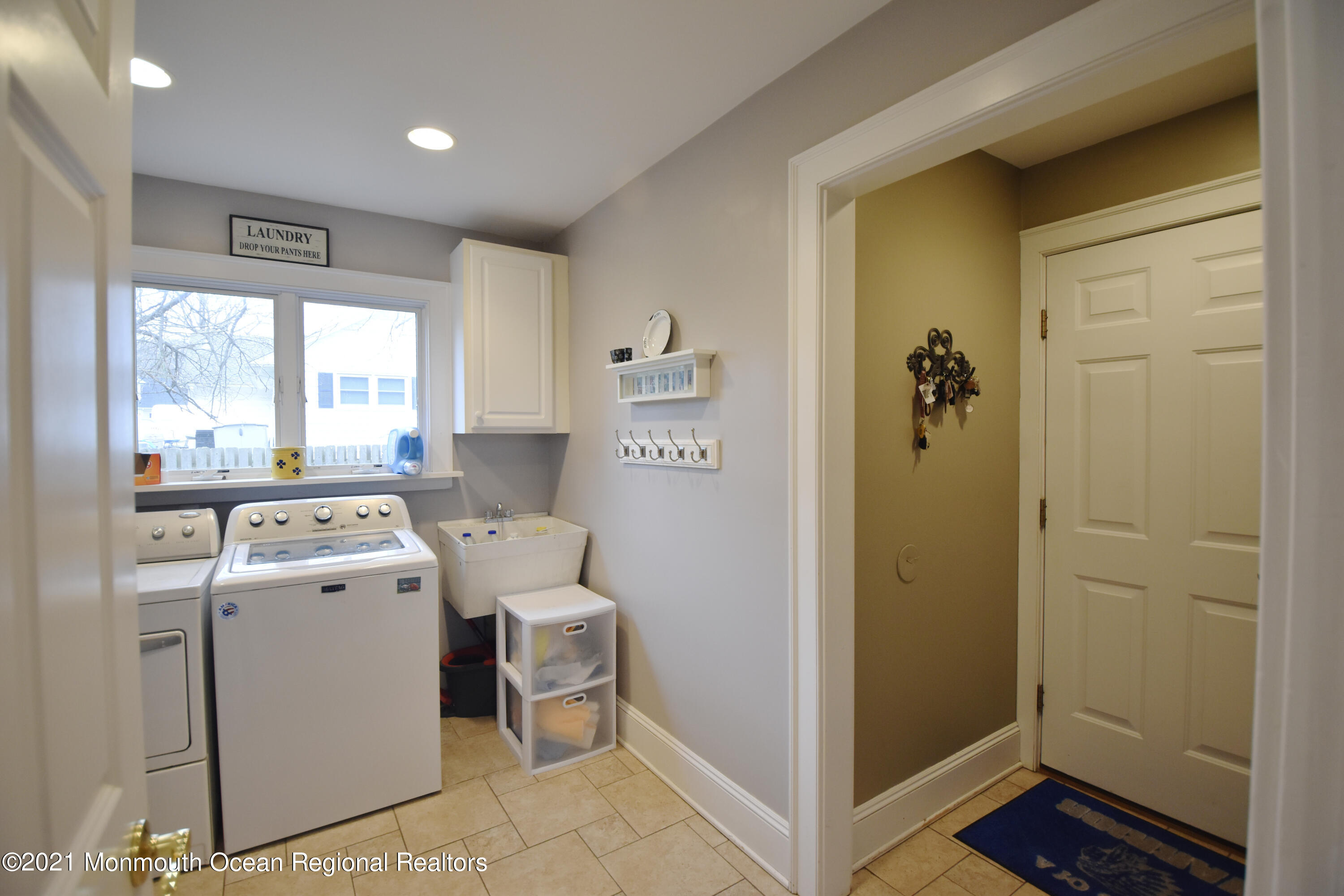 1007 Cedar Lane Brielle, NJ 08730 - Photo 38 of 46 a view of washer and dryer with kitchen in the background