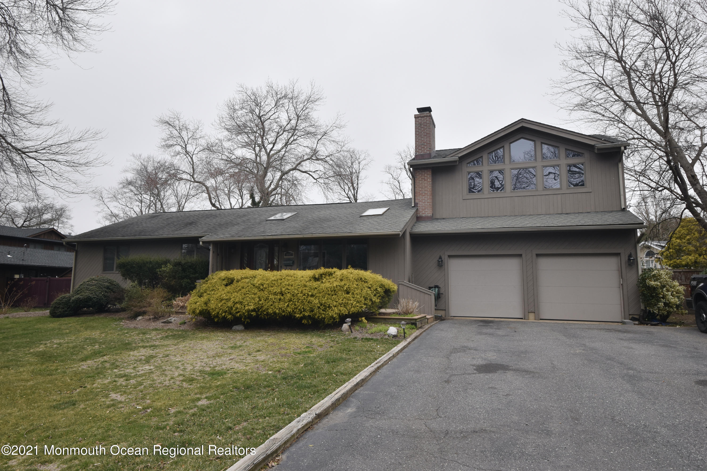 1007 Cedar Lane Brielle, NJ 08730 - Photo 45 of 46 a front view of a house with a yard and garage