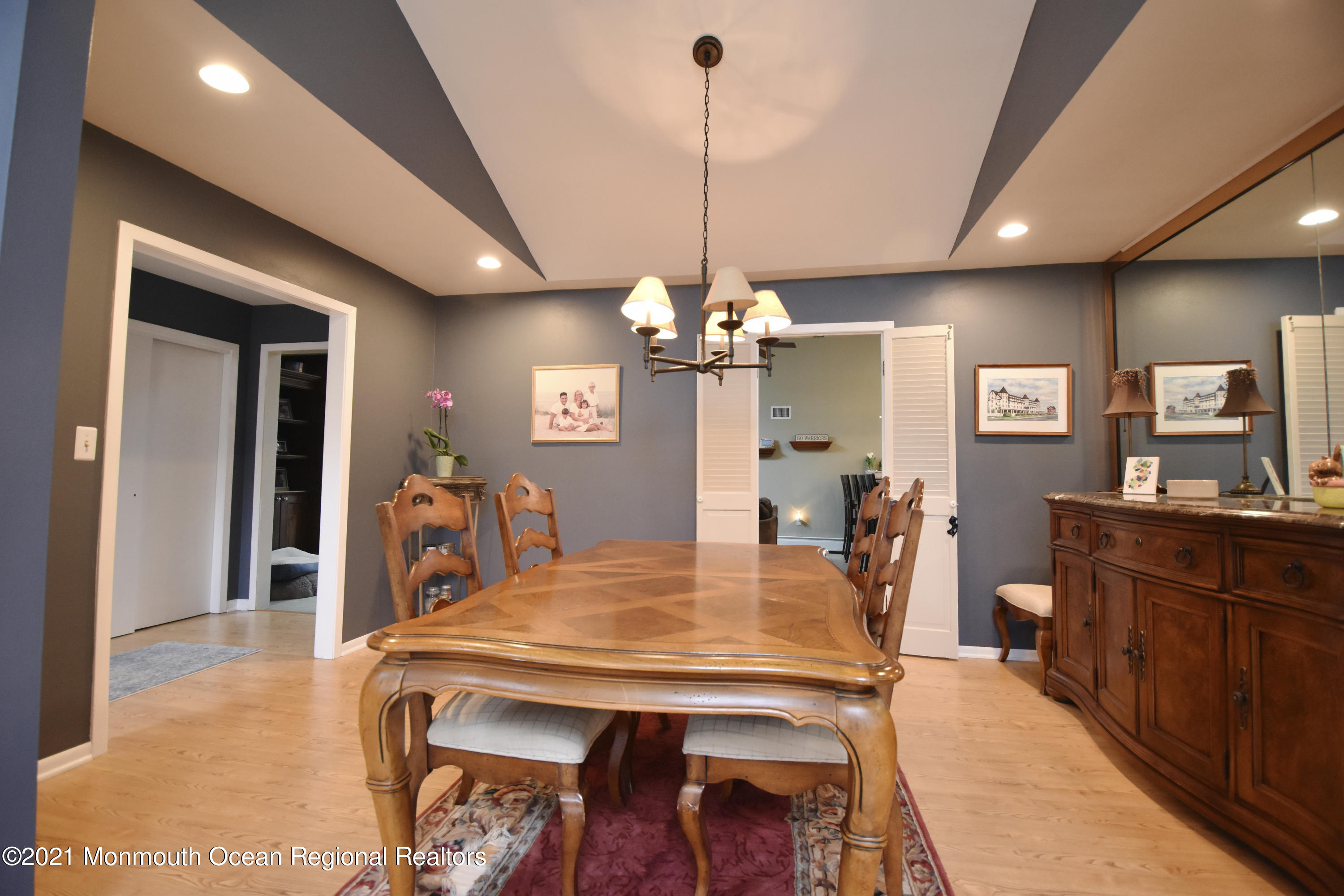 1007 Cedar Lane Brielle, NJ 08730 - Photo 10 of 46 a view of a dining room and livingroom with furniture wooden floor a chandelier