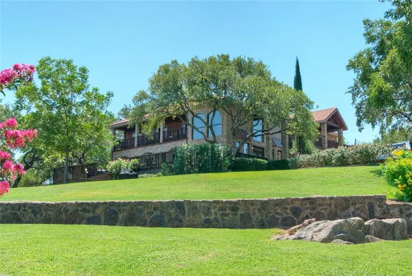 a view of a house with a yard and a garden