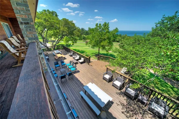a view of a chairs and table on the wooden deck