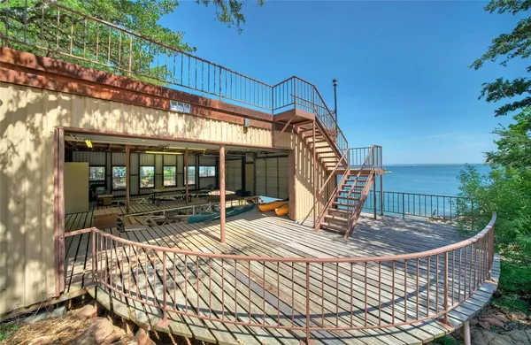 an aerial view of a house with a yard and lake view