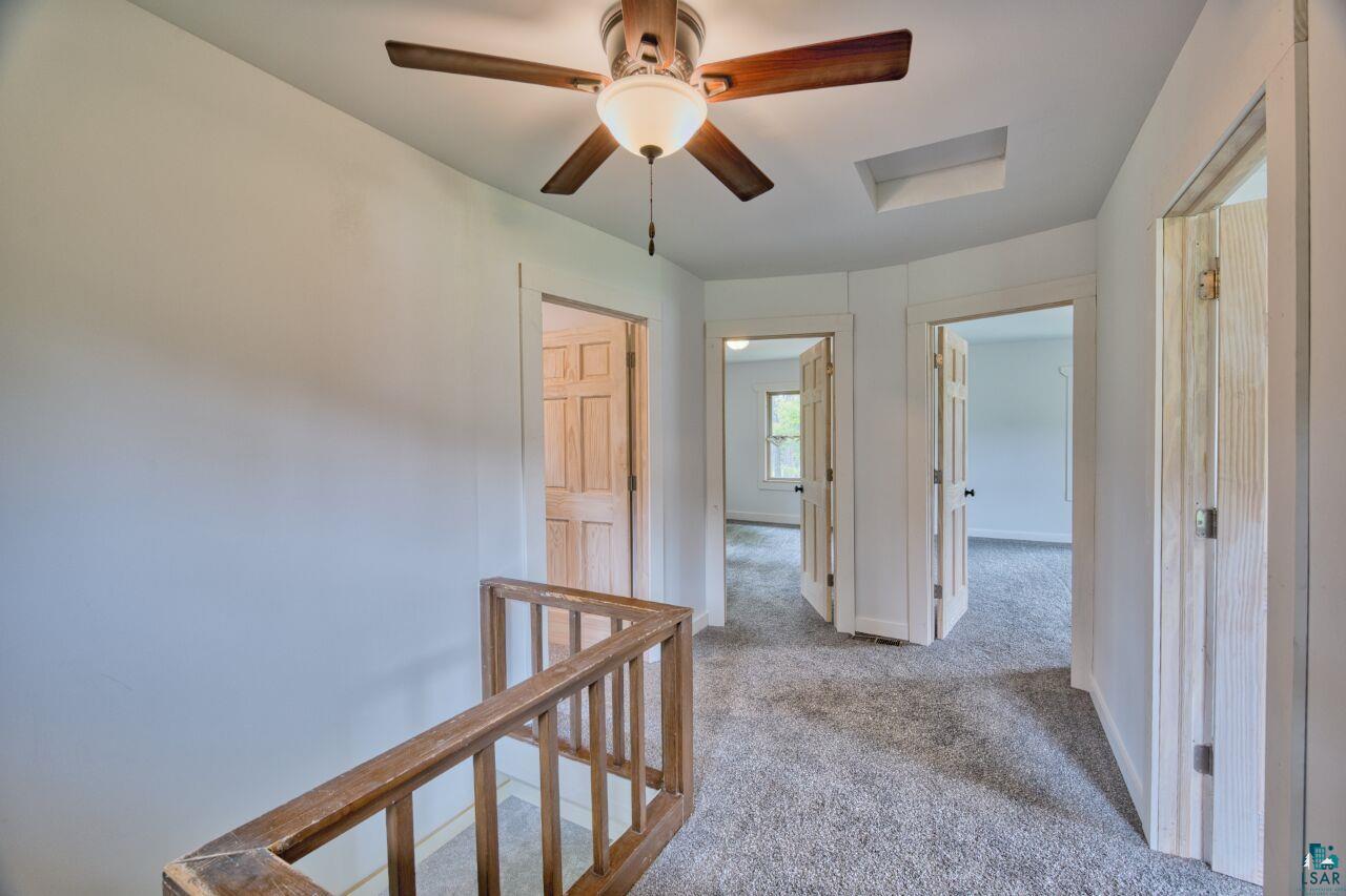 4755 Judd Road Gilbert, MN 55741 - Photo 17 of 50 Hall with an upstairs landing, carpet flooring, and baseboards