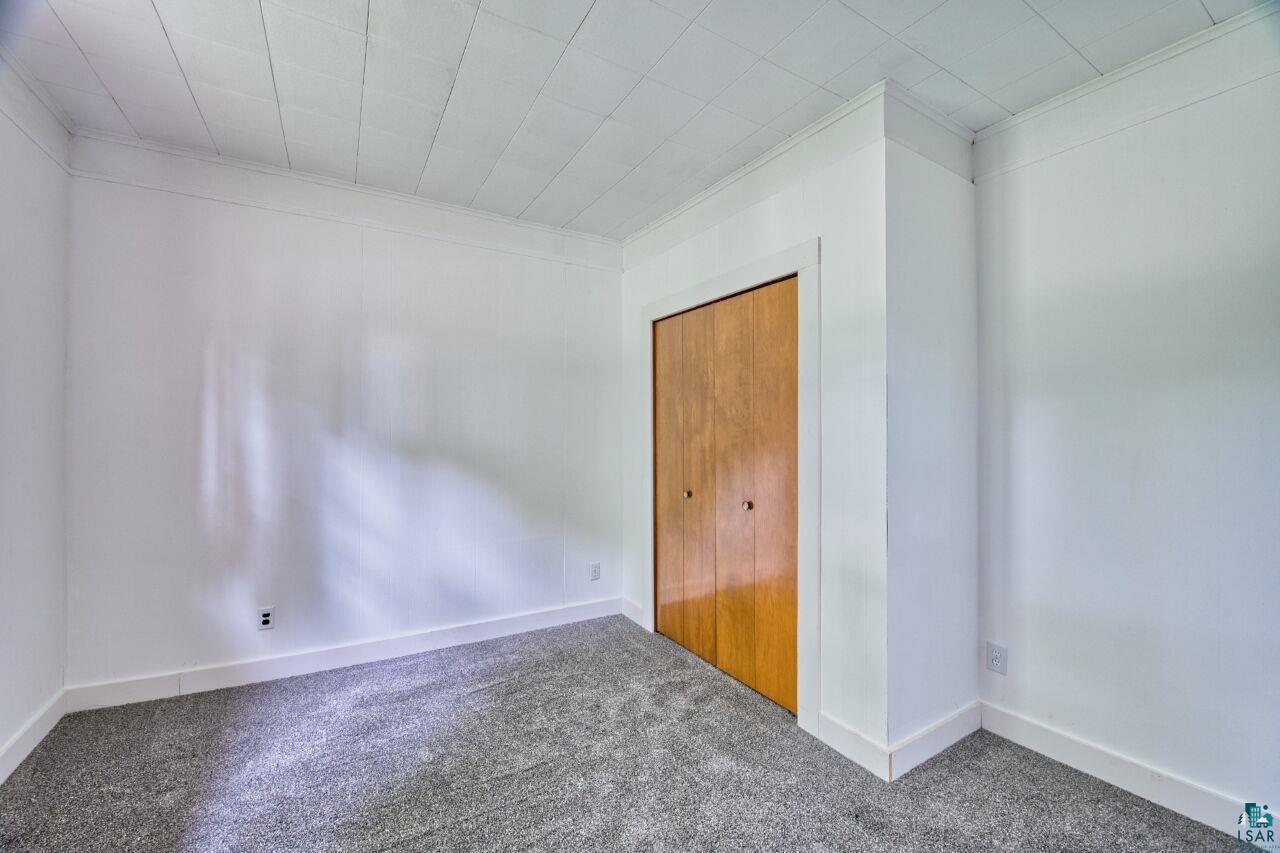 4755 Judd Road Gilbert, MN 55741 - Photo 19 of 50 Unfurnished bedroom with carpet, baseboards, and ornamental molding