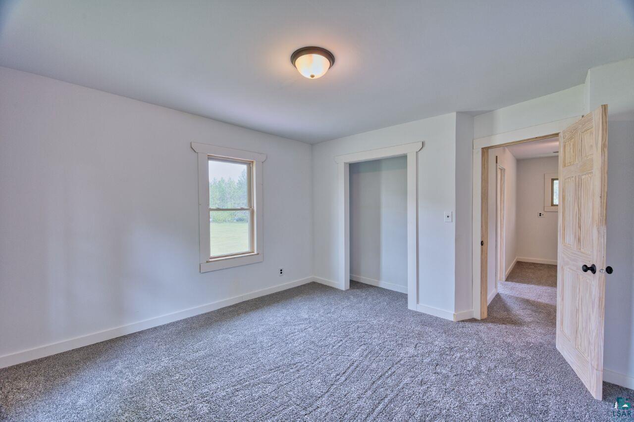4755 Judd Road Gilbert, MN 55741 - Photo 21 of 50 Unfurnished bedroom featuring carpet and baseboards
