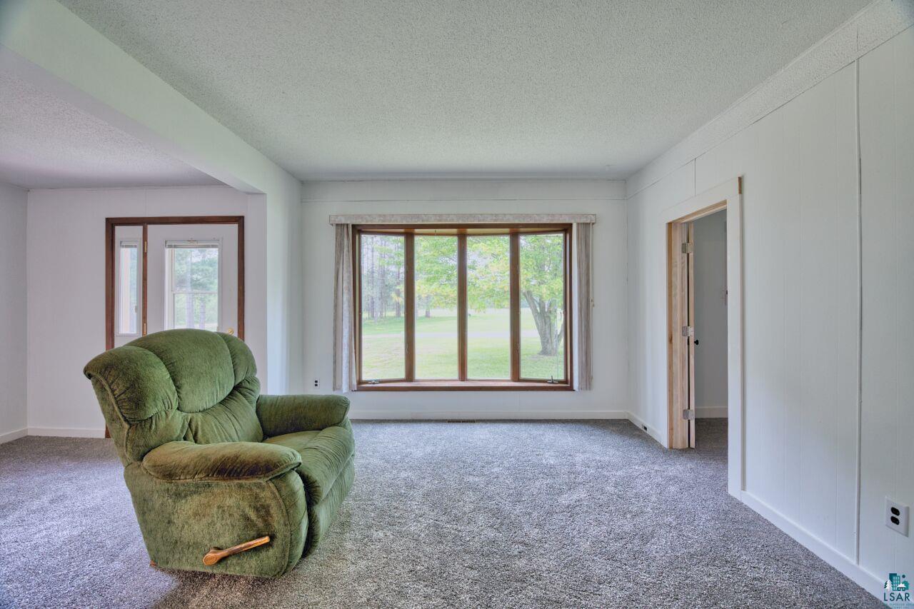 4755 Judd Road Gilbert, MN 55741 - Photo 3 of 50 Sitting room with a textured ceiling, carpet flooring, and baseboards