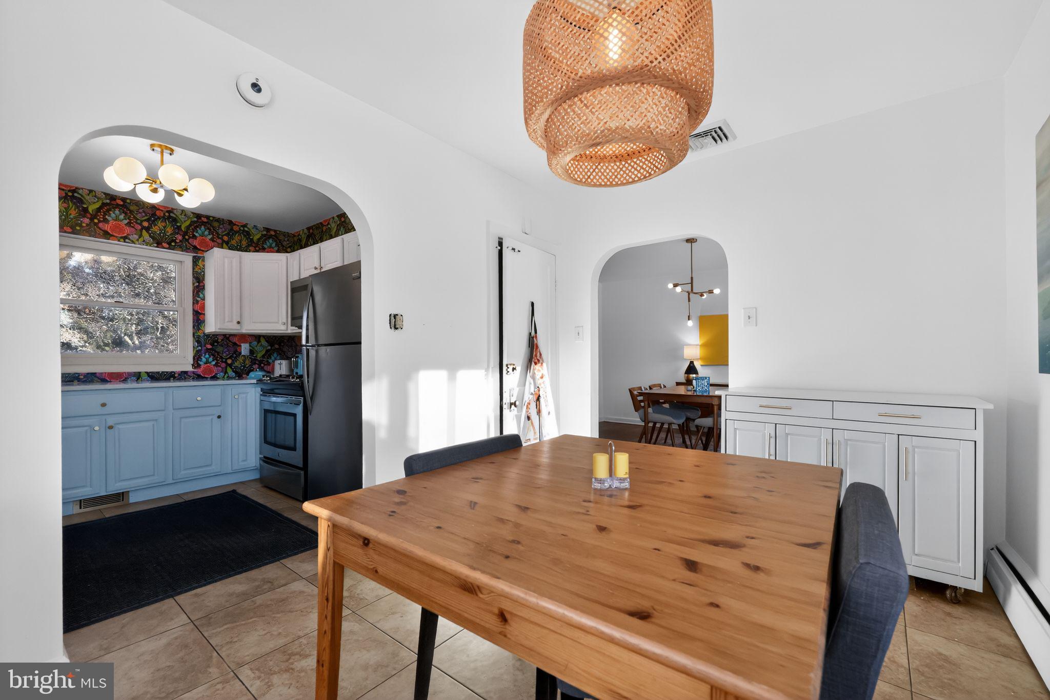 711 Brookhaven Road Wallingford, PA 19086 - Photo 12 of 35 a kitchen with a table chairs and a wooden floor