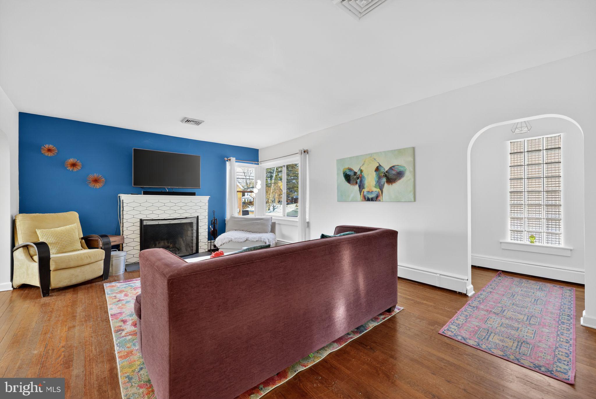 711 Brookhaven Road Wallingford, PA 19086 - Photo 2 of 35 a living room with furniture a fireplace and a flat screen tv