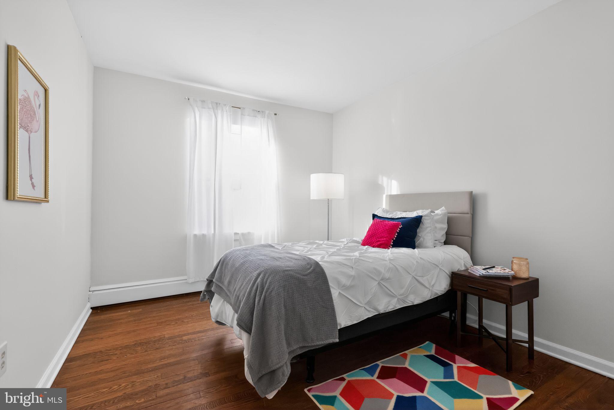 711 Brookhaven Road Wallingford, PA 19086 - Photo 21 of 35 a bedroom with a bed and wooden floor