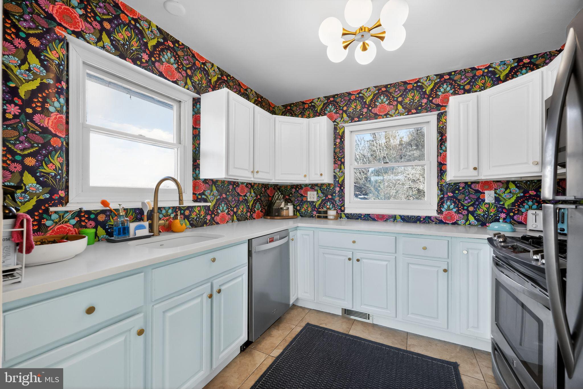 711 Brookhaven Road Wallingford, PA 19086 - Photo 9 of 35 a kitchen with granite countertop a sink stainless steel appliances and cabinets