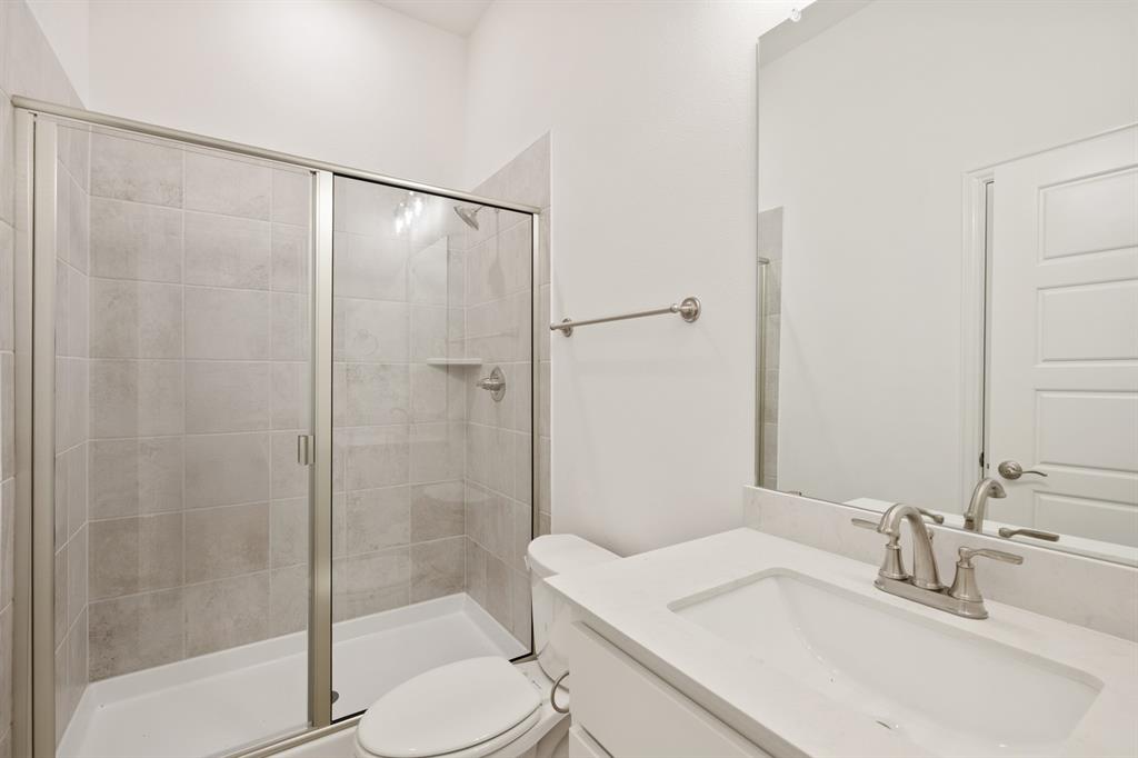 735 Oak Lavon, TX 75166 - Photo 13 of 39 a bathroom with a sink toilet and shower
