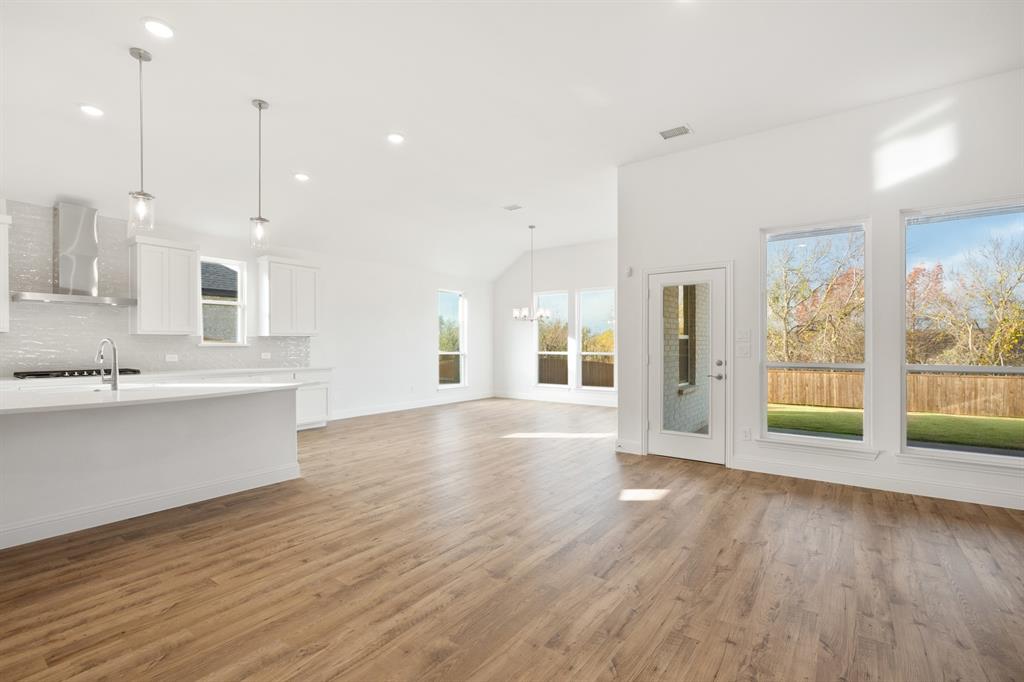 735 Oak Lavon, TX 75166 - Photo 18 of 39 a view of large kitchen with large windows and wooden floor